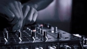 dj-using-mixing-console